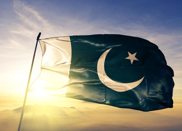 Pakistan flag with sun behind it
