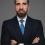 Malek Sarieddine standing in a suit with crossed arms