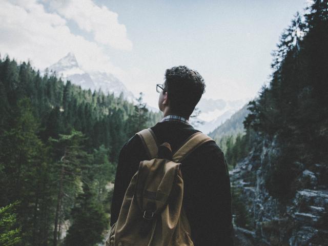 man looking at mountains