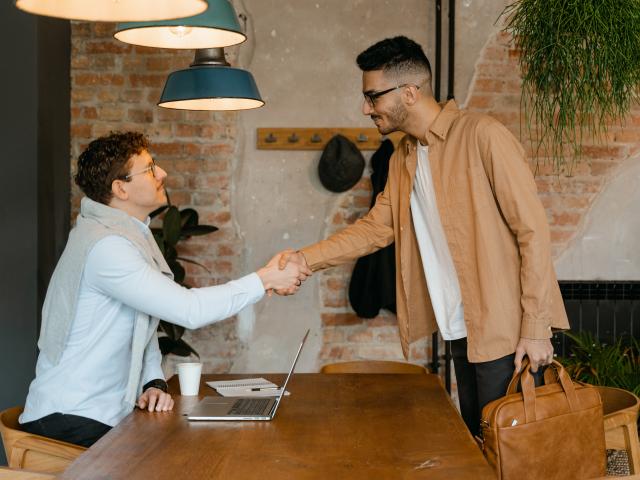 Two men standing and shaking hands