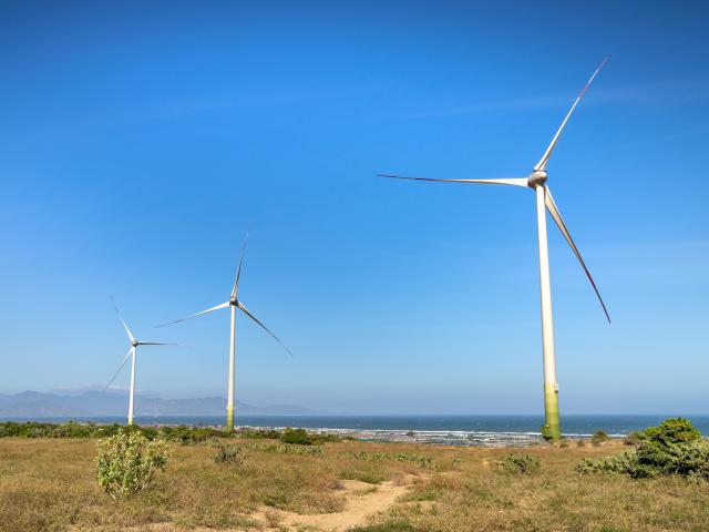 Windmills by oceans shore