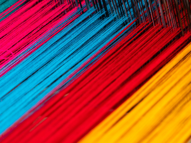 A loom with colorful threads in it