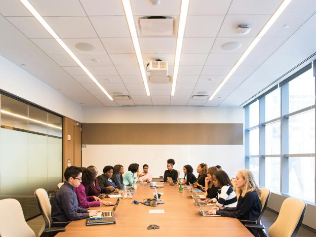 people in a board room sitting down