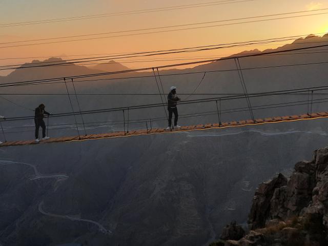 People walking across a rope bridge in Saudi Arabia