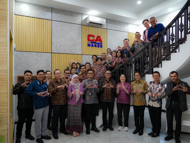 Attendees of a meeting at IAI headquarters on a staircase