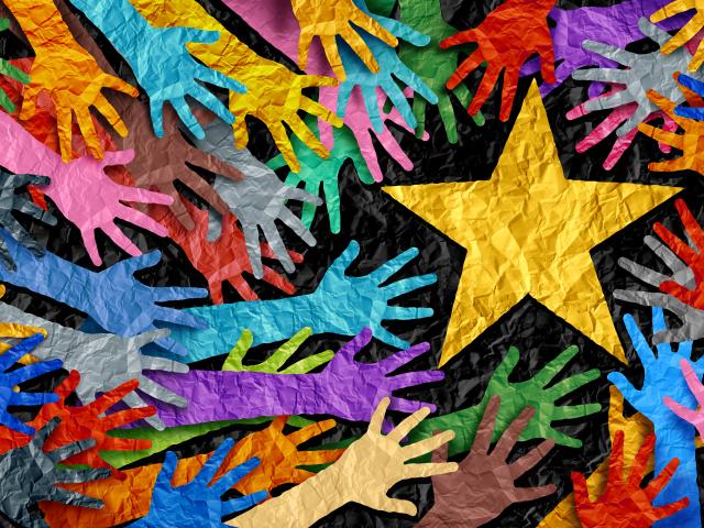Colorful paper hands reaching for yellow paper star