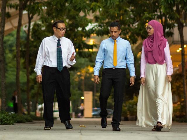 Three business people walking in Indonesian city