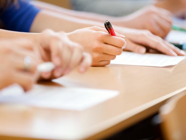 Close up of writing hands of university students