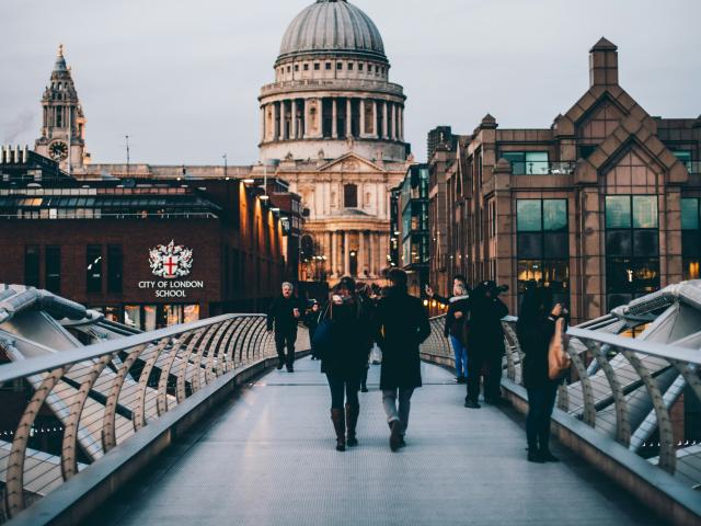 People crossing the Millennium Bridge in London, England