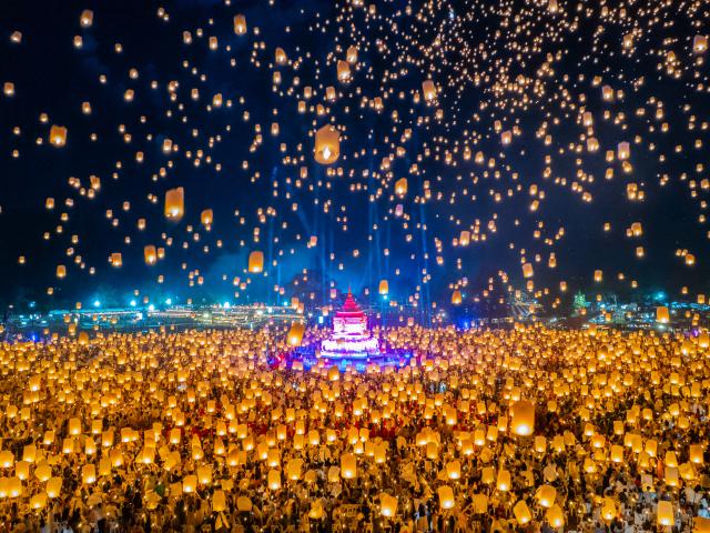 A huge crowd releases beautiful lanterns into the night sky