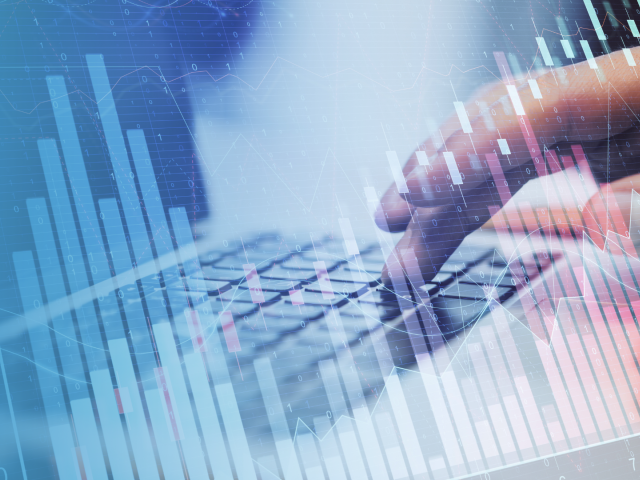A blue background with hands typing on a keyboard overlayed with graphs