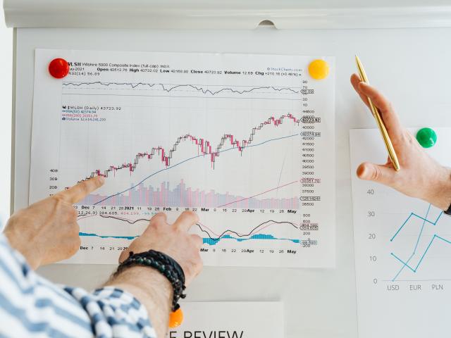 Hands near charts showing growth