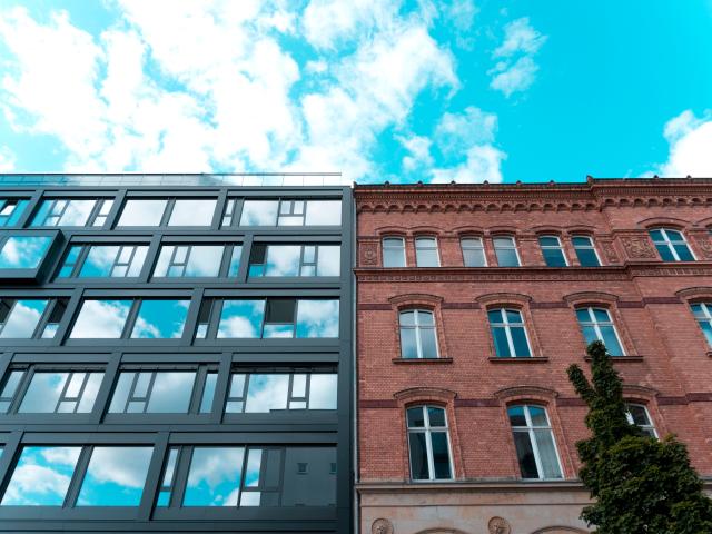 Two buildings next to each other, one old and one new