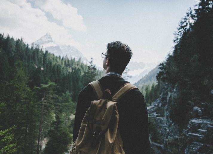 man looking at mountains