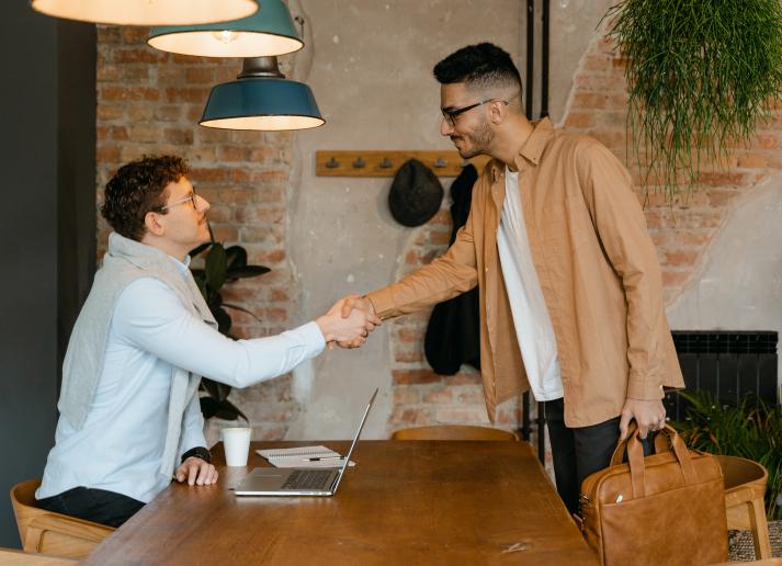 Two men standing and shaking hands