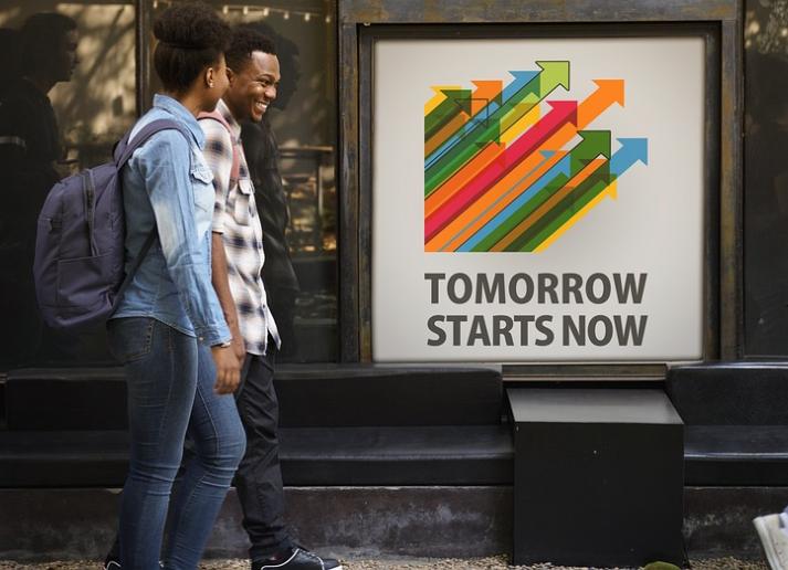 Students walking past an inspiring poster outside