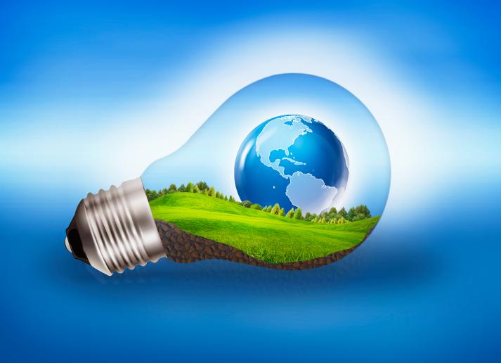 Graphic showing a globe and green landscape inside a transparent light bulb on a blue background