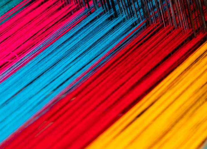 A loom with colorful threads in it