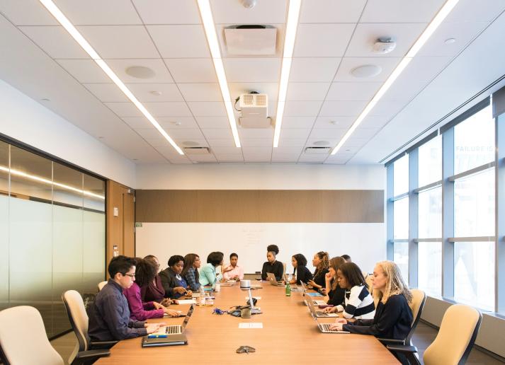 people in a board room sitting down