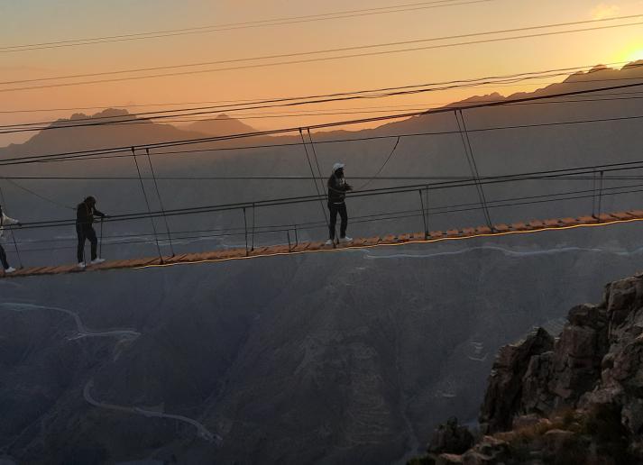 People walking across a rope bridge in Saudi Arabia