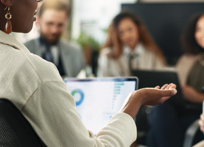 A woman addresses a small sitting group