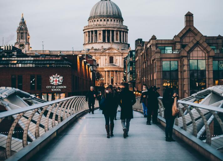People crossing the Millennium Bridge in London, England