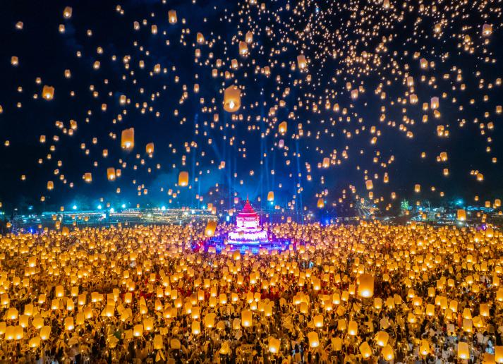 A huge crowd releases beautiful lanterns into the night sky