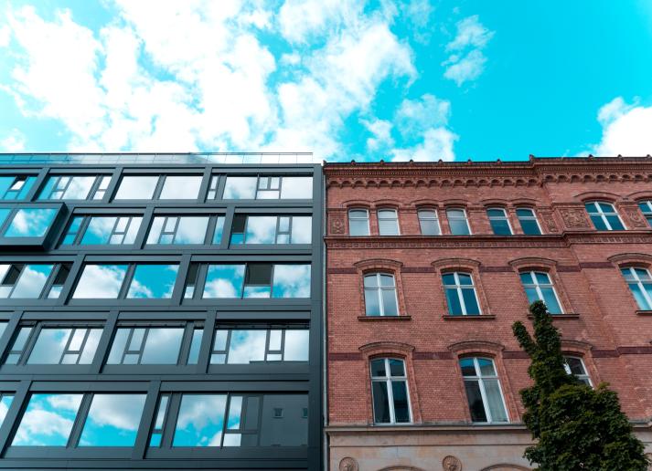 Two buildings next to each other, one old and one new