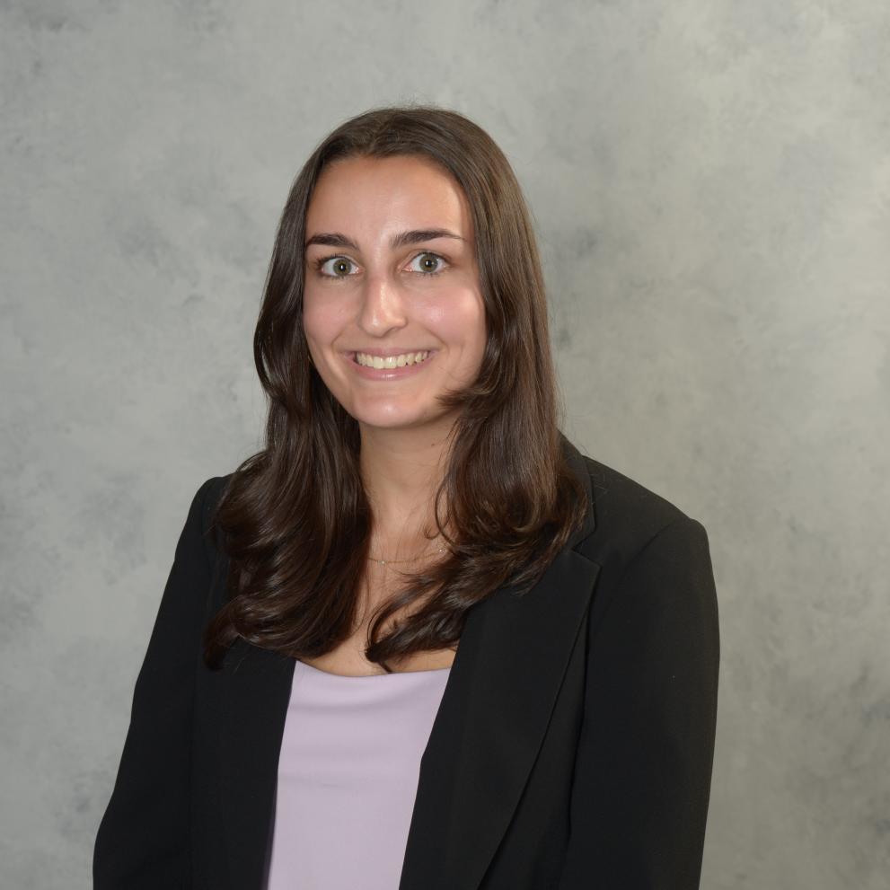 Woman smiling and wearing black blazer