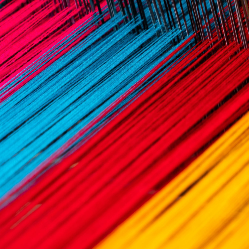 A loom with colorful threads in it
