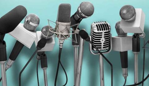 Microphones set up as if for a press conference