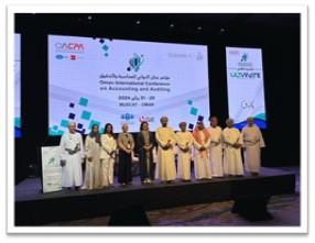 A group of 11 people standing on stage at a conference