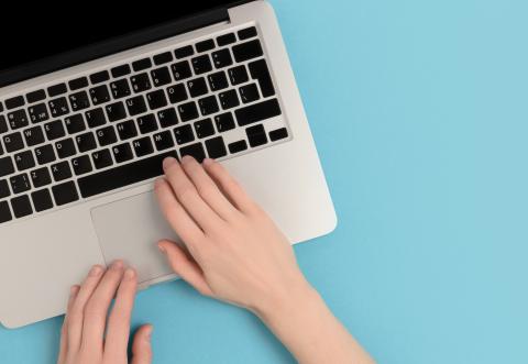 Someone typing on a computer keyboard