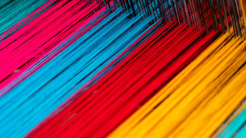 A loom with colorful threads in it