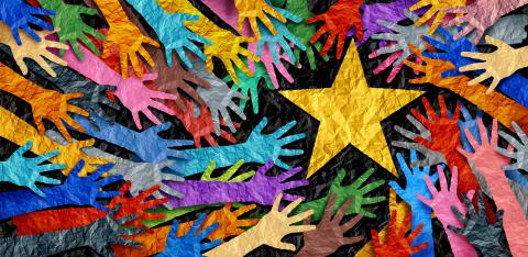 Colorful paper hands reaching for yellow paper star