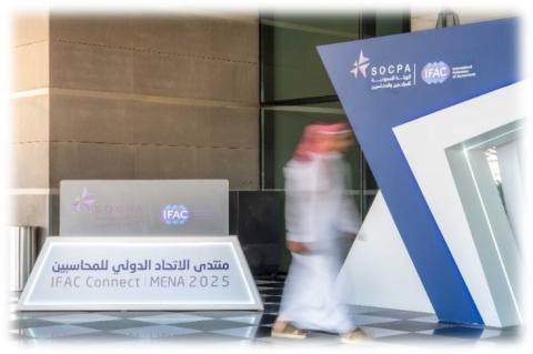 Man walking in front of signage
