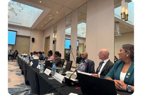 A row of people attending a meeting, all seated