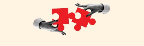 Hands connecting red puzzle pieces on a tan background