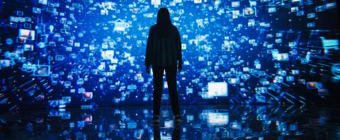A person standing in front of a digital screen