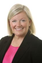A photo of a woman smiling at the camera