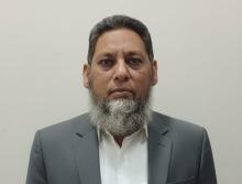 A man in a blazer and white shirt